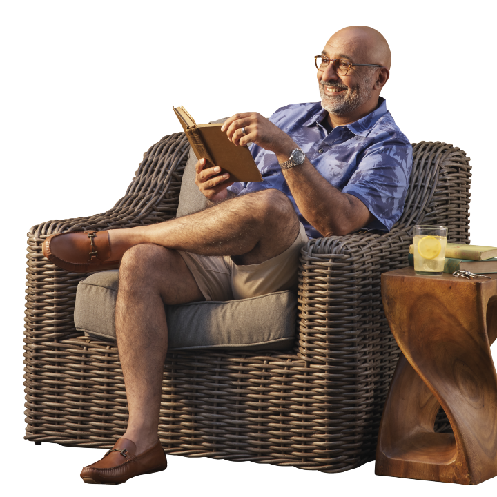 older man reading a book at his resort home